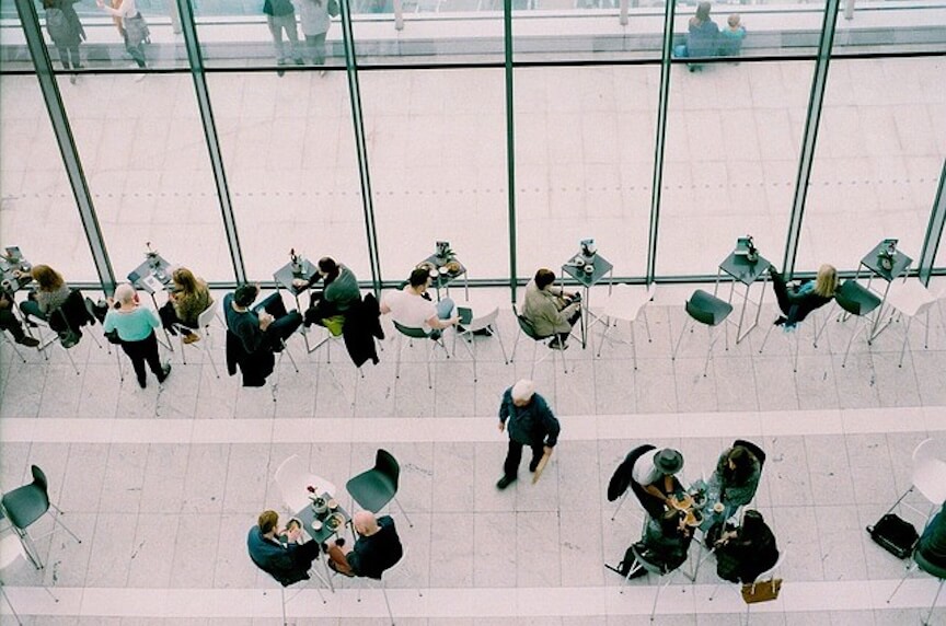 A shot looking down at people walking around inside a building.