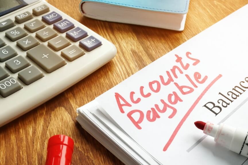 A professional reviewing financial records and invoices for an audit