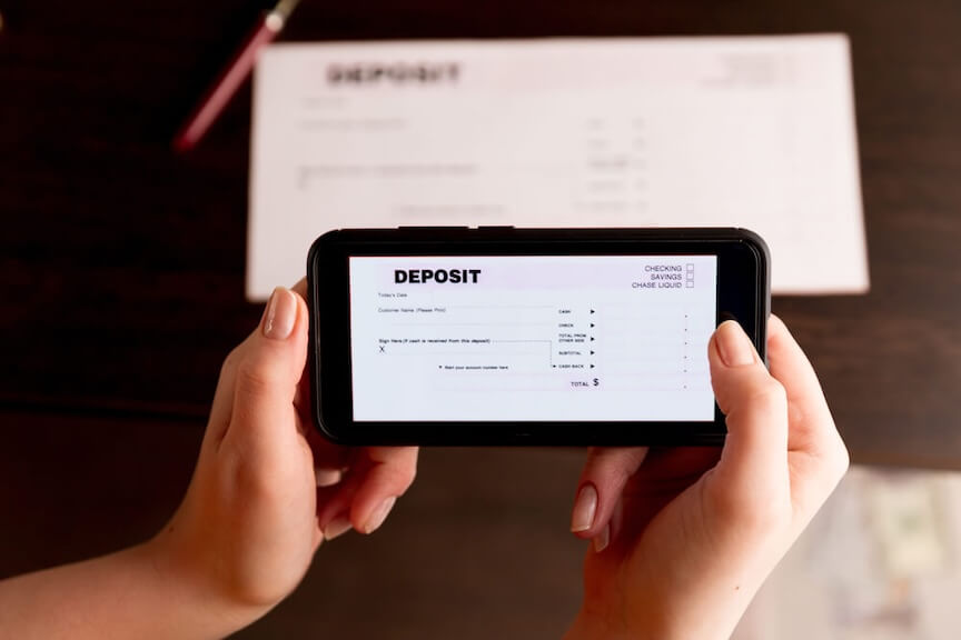 A picture of a smartphone screen showing a check being deposited