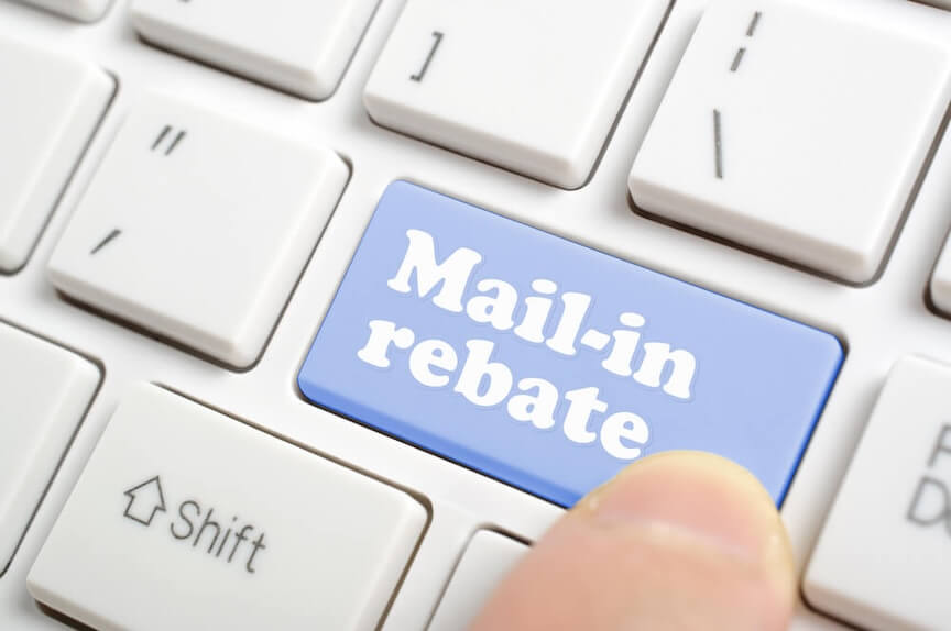 A picture of a mail-in rebate form with a check on top of it