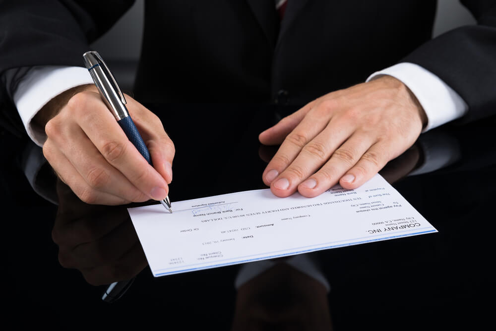 Man Signing a Check