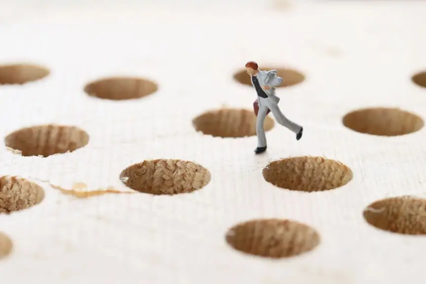 A graphic showing a person running from traps, symbolizing common ACH errors