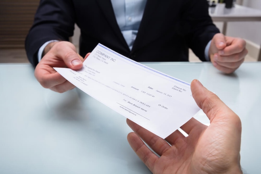A business professional delegating tasks to an outsourced check printing service
