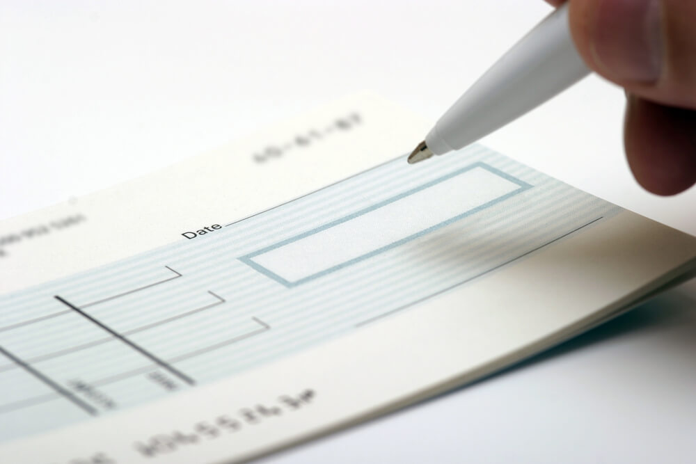 A Generic Blank Check Being Signed