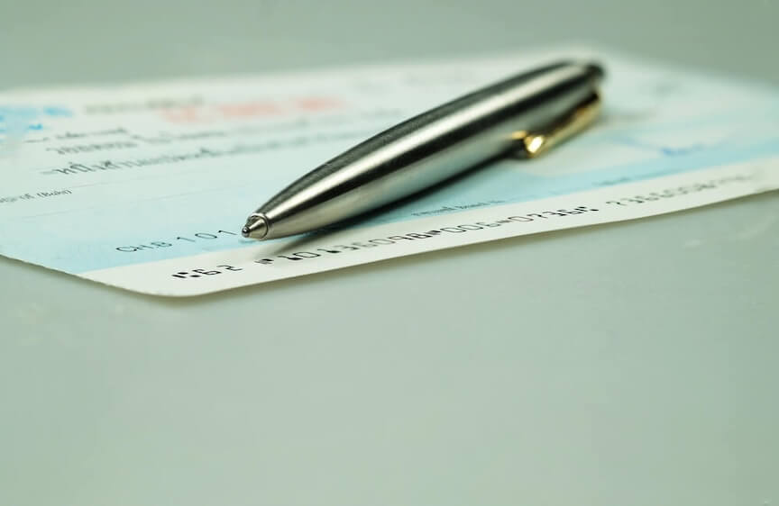 A close-up of a check with the cents portion of the written amount filled out correctly