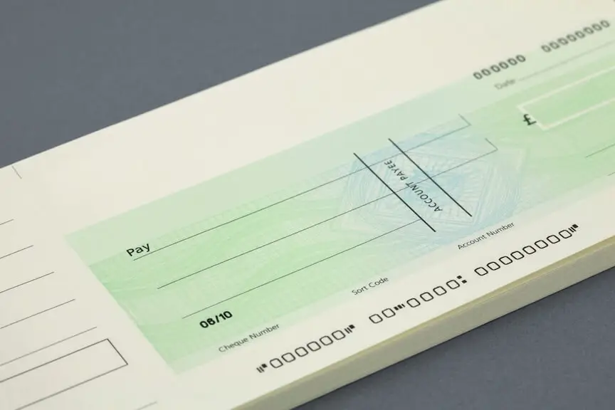 A picture of a pile of checks with a clock icon on them