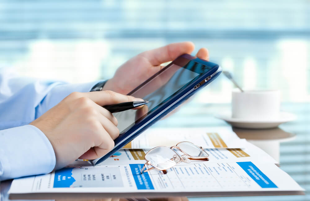 A Business Man Working on His Tablet