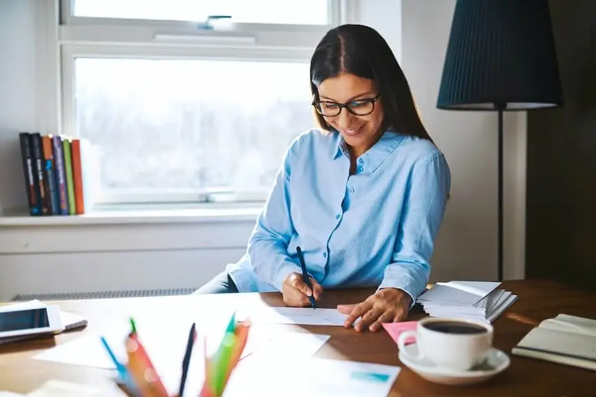 A picture of a business professional reviewing contracts for a payroll check printing service