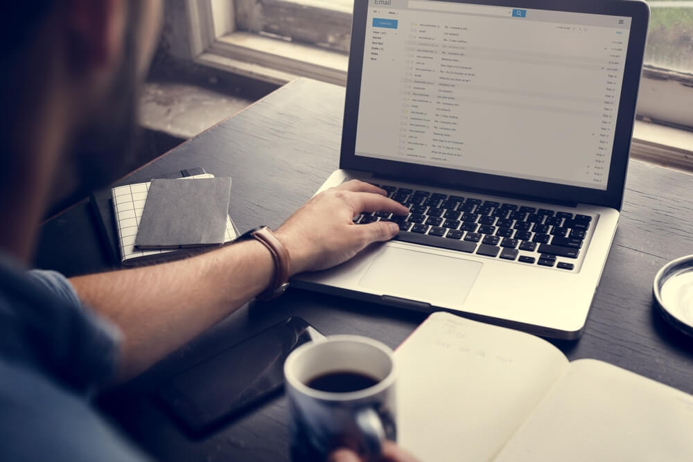 Businesswoman Checking E-Mail Online on Laptop