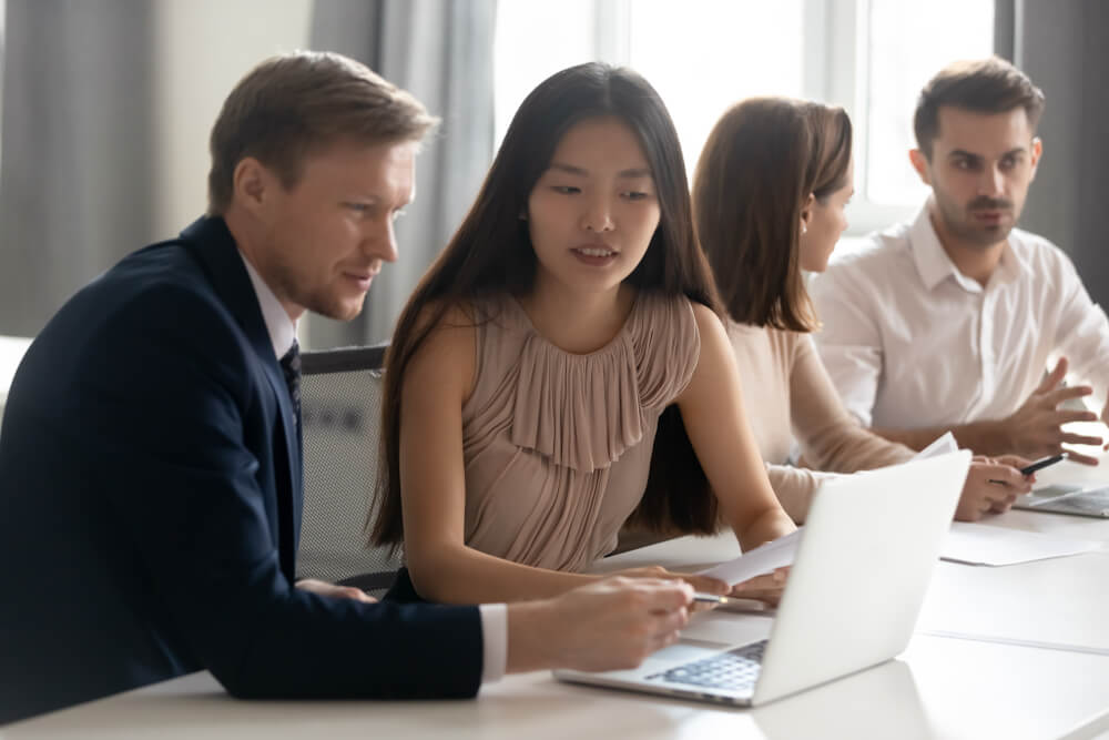 Mentor Coach Helping Asian Female Employee 