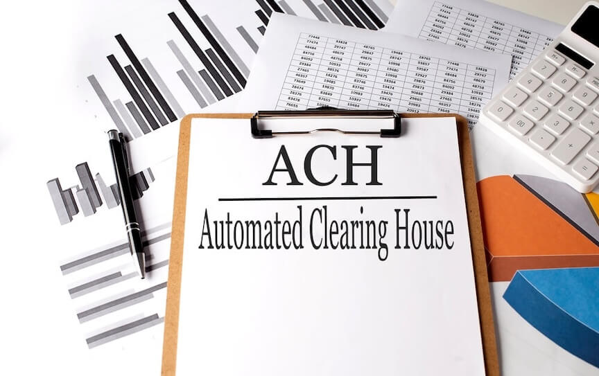 A clipboard that says ACH