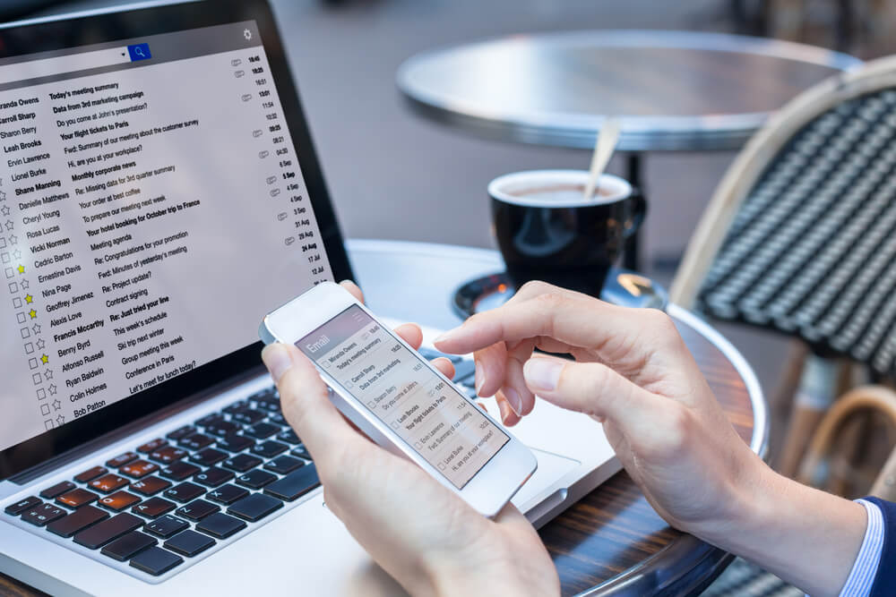 Business Person Reading Emails On Smartphone And Laptop Computer Screen Online Communication And Marketing Concept